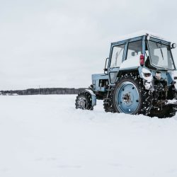 Tractors cleaning snow from field